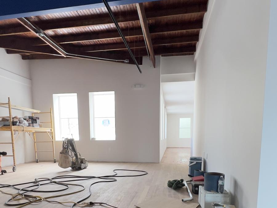 Original wood floor being sanded in a loft with exposed beams