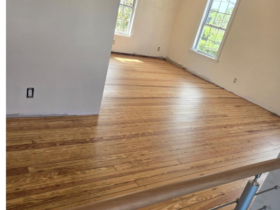 Refinished heart pine floor in a sunlit upstairs room